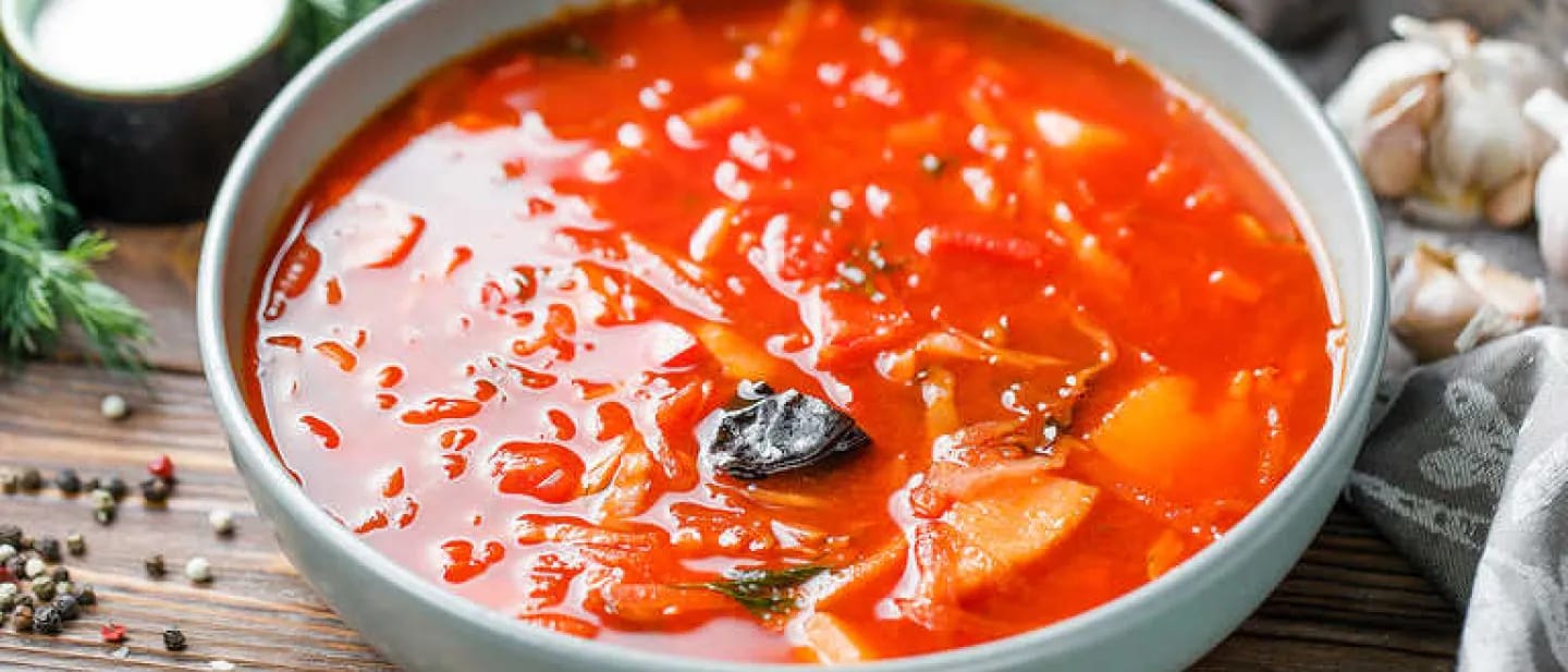 Traditional Ukrainian soup with beets, tomatoes, and pork ribs