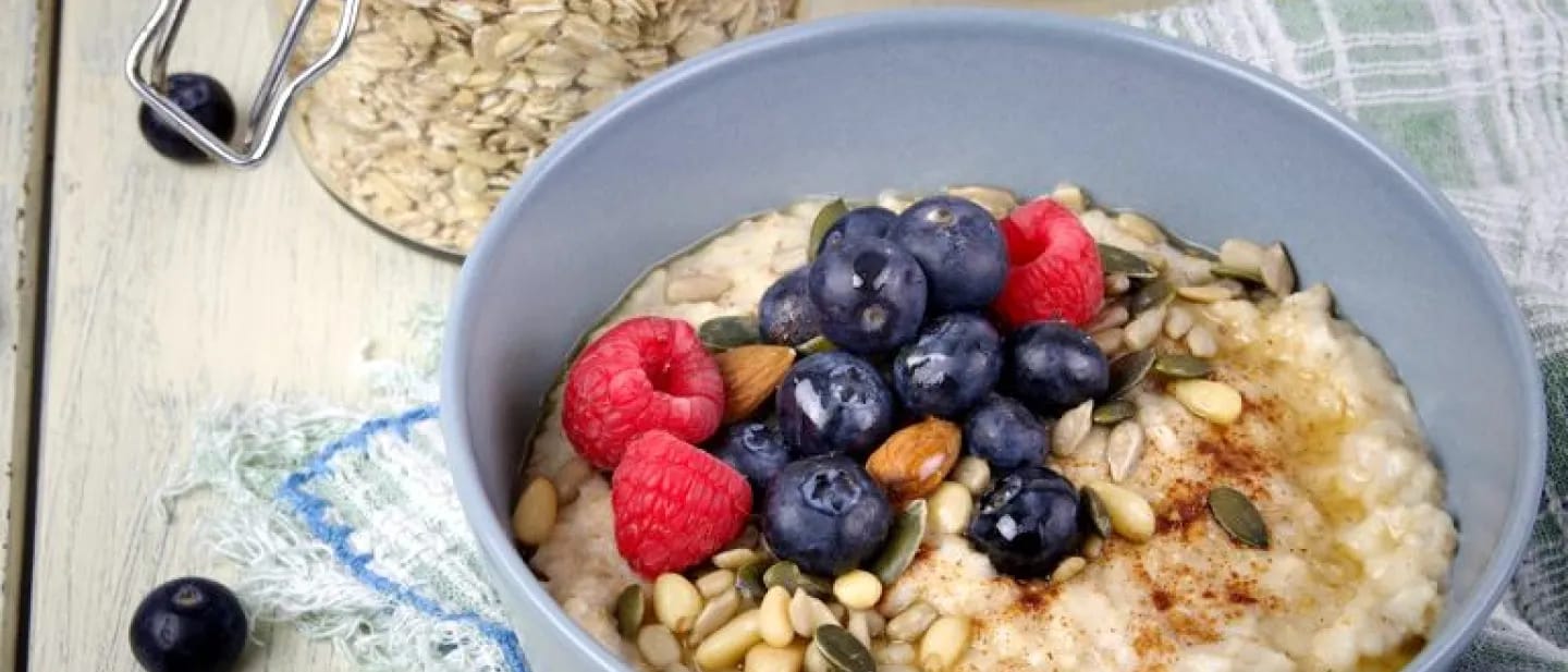 Oatmeal topped with a vibrant mix of berries, nuts, and seeds