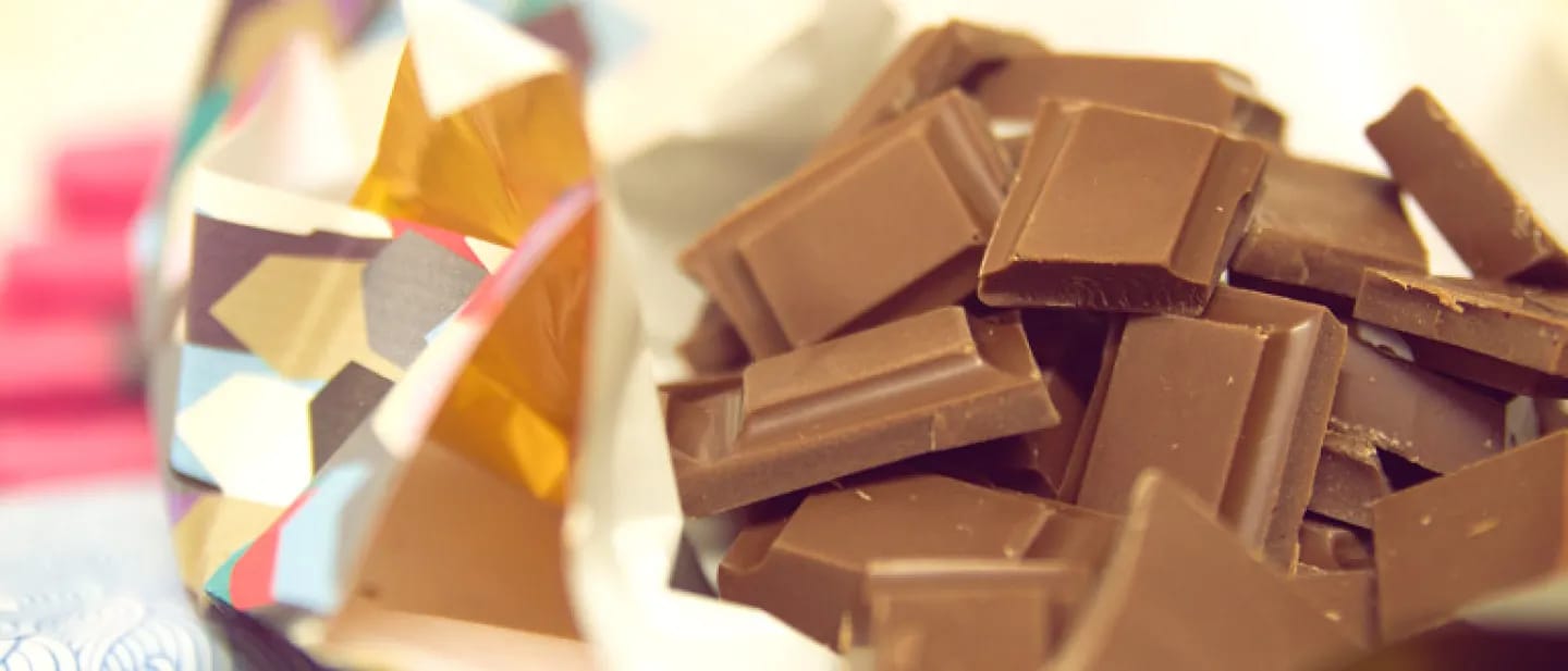 A delicious bar of dairy-free milk chocolate, broken into pieces