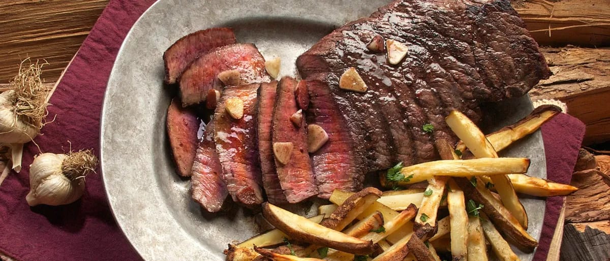 Sliced steak on a Plate with Fries on the Side