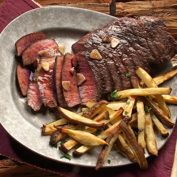 Sliced steak on a Plate with Fries on the Side