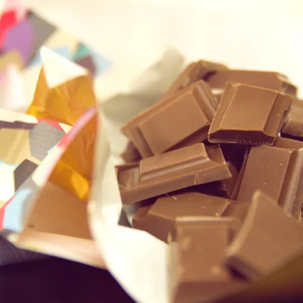 A delicious bar of dairy-free milk chocolate, broken into pieces