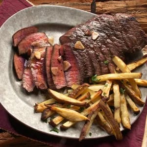 Sliced steak on a Plate with Fries on the Side